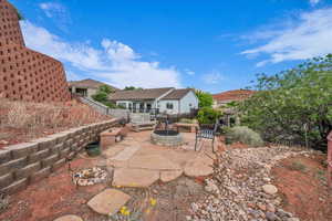 View of patio / terrace with a fire pit and fence