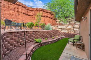 View of yard featuring a patio and an area to practice putting