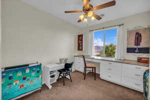 Office with carpet flooring, ceiling fan, baseboards, and built in study area