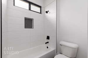Bathroom with toilet and tub / shower combination