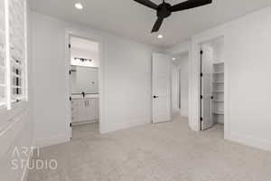 Unfurnished bedroom with light colored carpet, recessed lighting, baseboards, a spacious closet, and ensuite bathroom