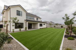 Back of house featuring stucco siding and a patio