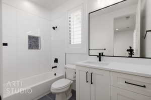 Full bathroom with toilet, vanity, washtub / shower combination, and tile patterned floors