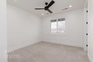 Carpeted spare room with a ceiling fan, recessed lighting, and baseboards