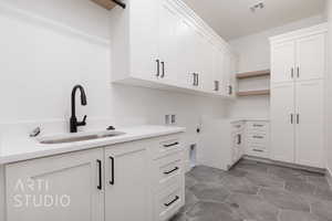 Washroom featuring cabinet space, electric dryer hookup, and hookup for a washing machine
