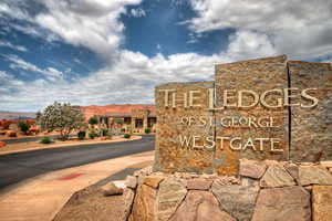 Community / neighborhood sign with a mountain view