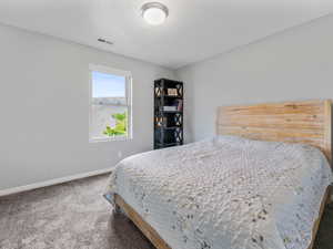 Carpeted bedroom featuring baseboards
