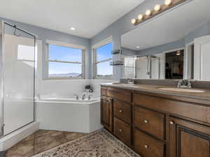 Full bathroom with a shower stall, a garden tub, double vanity, tile patterned floors, and recessed lighting