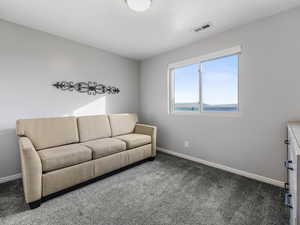 Carpeted living area with baseboards