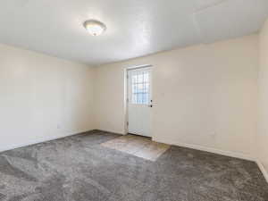 Carpeted empty room with baseboards