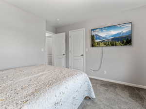 Carpeted bedroom with baseboards