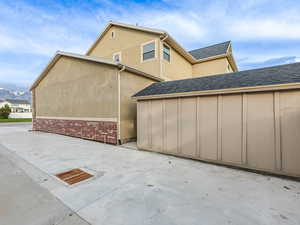 View of property exterior with a patio and stucco siding