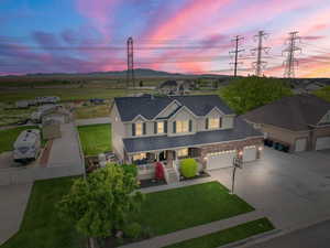 View of front of house featuring a porch, concrete driveway, and a garage