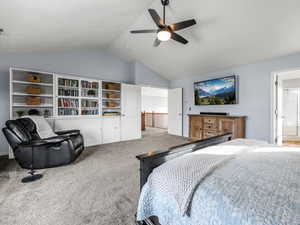 Bedroom featuring carpet, high vaulted ceiling, a ceiling fan, and ensuite bathroom