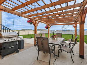 View of patio / terrace with outdoor dining area, grilling area, and a pergola