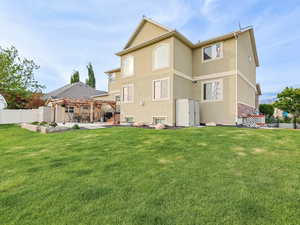 Back of house featuring a pergola, a patio, and stucco siding