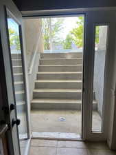 Stairs featuring tile patterned flooring