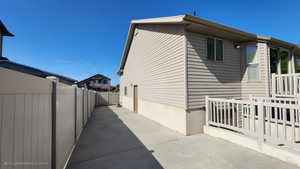 View of home's exterior with fence and a patio