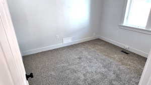 Unfurnished room with carpet floors and baseboards