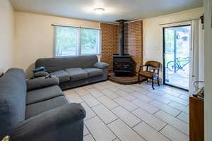 Second Living room with a wood stove, crown molding, and plenty of natural light