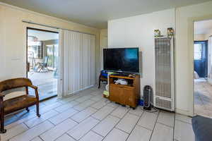 Second Living room with a heating unit and crown molding