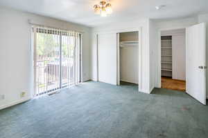 Upstairs bedroom with glass sliding doors to  access balcony.