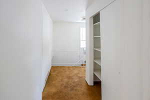 Hall with carpet and an upstairs landing
