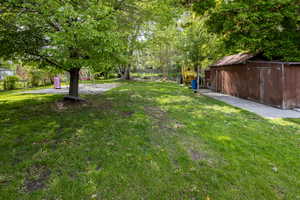 View of yard with a shed and an outdoor structure