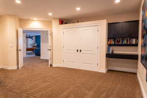 Unfurnished bedroom with carpet flooring, a closet, recessed lighting, and baseboards