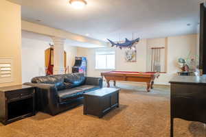 Game room featuring light carpet, decorative columns, and billiards