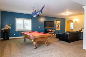 Playroom with carpet floors, arched walkways, billiards, and baseboards