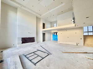 Unfurnished living room with a high ceiling