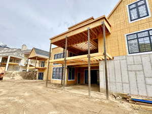 Rear view of house featuring a patio and a balcony