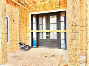 Property entrance featuring french doors