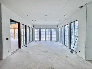 Empty room featuring unfinished concrete flooring