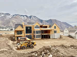 Rear view of house featuring a mountain view and a balcony
