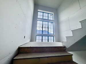 Staircase with a high ceiling and plenty of natural light