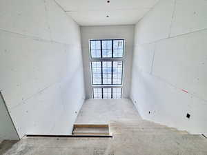 Unfurnished room with unfinished concrete flooring