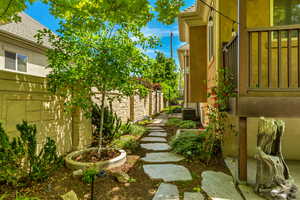 View of yard with fence and central AC