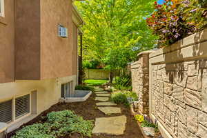 View of home's exterior with stucco siding and fence