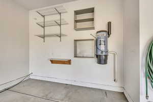 Detailed view of concrete flooring and a central vacuum unit