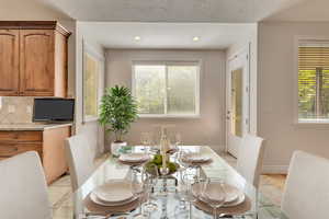 Dining area featuring healthy amount of natural light, recessed lighting, and baseboards