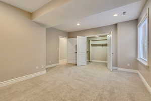 Unfurnished bedroom featuring recessed lighting, light carpet, and baseboards
