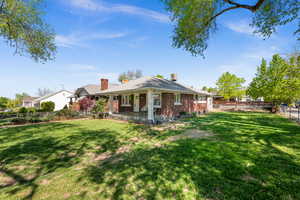 Back of property with brick siding and a chimney