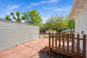 View of patio featuring a deck and fence