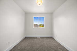 Carpeted empty room with baseboards