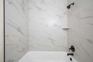 Full bathroom with shower / bathtub combination