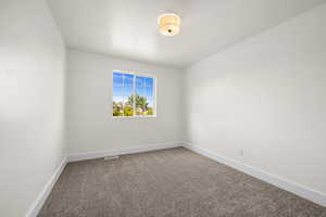 Unfurnished room featuring carpet and baseboards