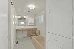 Full bathroom with a sink and vintage tub