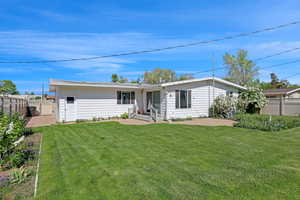 Back of home with patio areas and walkway to garage door